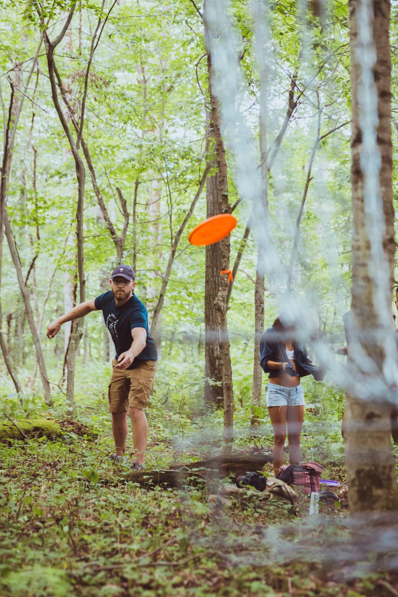 Playing disc golf in woods